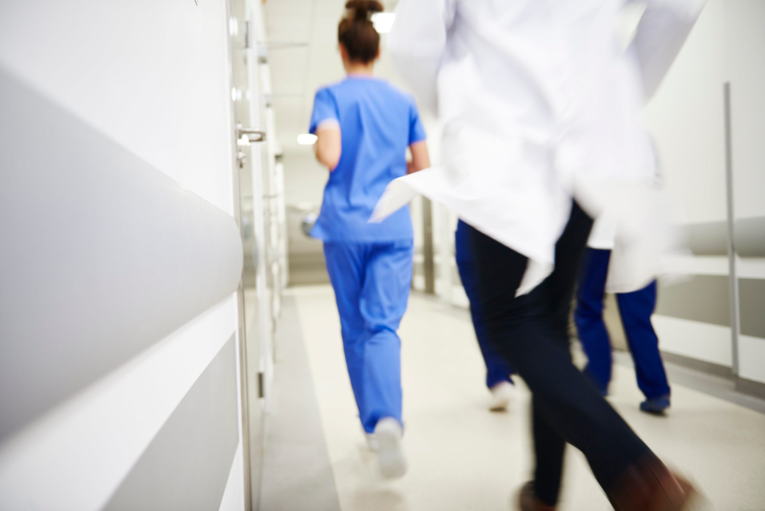 hospital workers run from emergency
