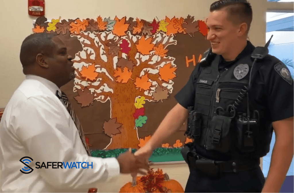 police officer shaking the hand of a community member - SaferWatch