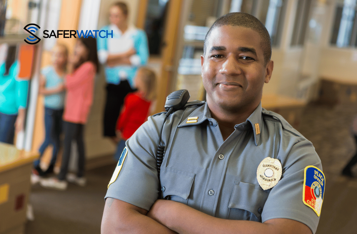 police officer smiling standing in a school - SaferWatch