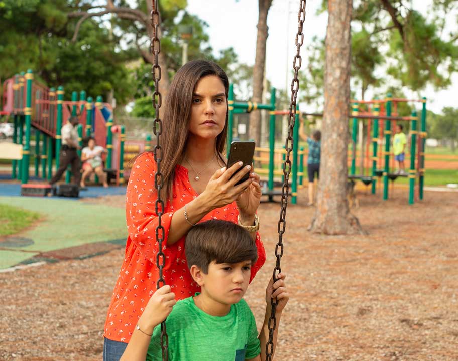 mother filming suspicious person on playground