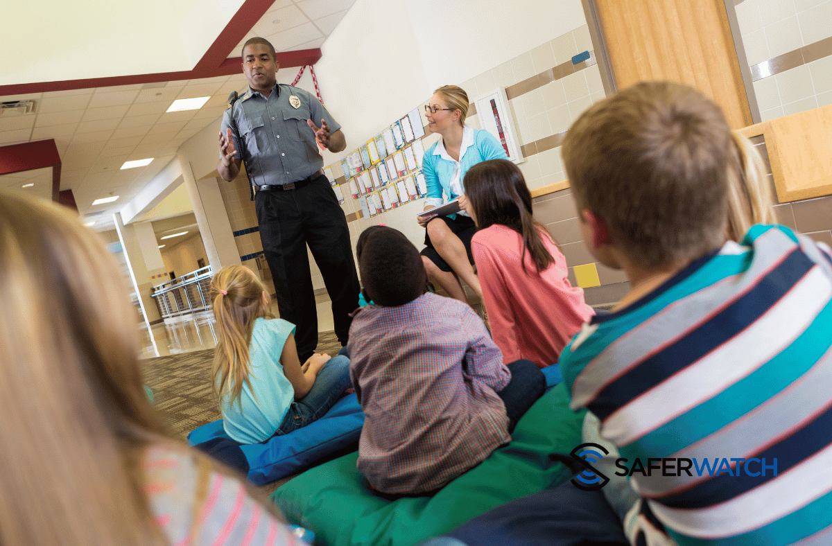 Officer discussing safety with a class of young students - SaferWatch