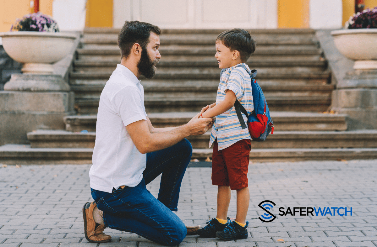 father talking to son outside of school - SaferWatch