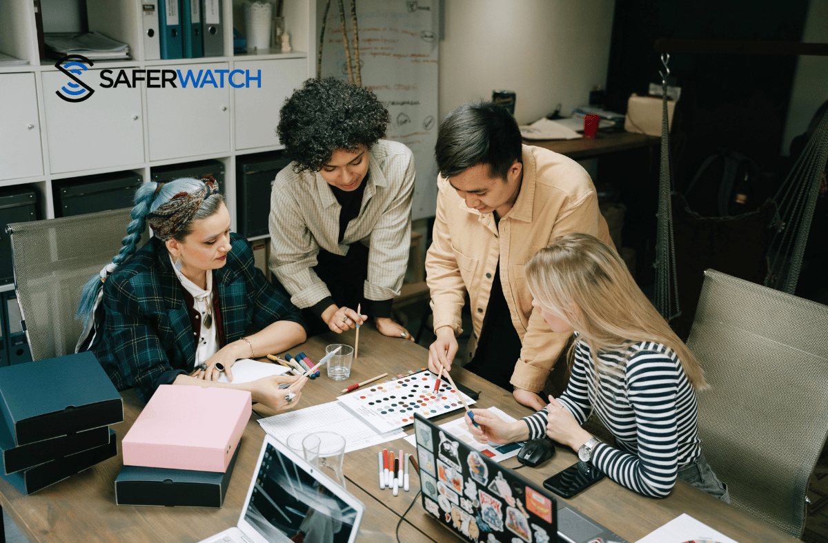 Teachers discussing a safety plan in a school teacher's office - SaferWatch