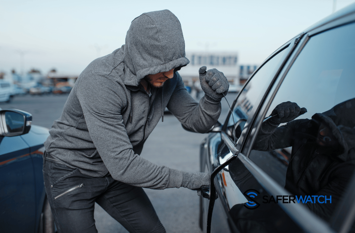 man breaking into a parked car - SaferWatch